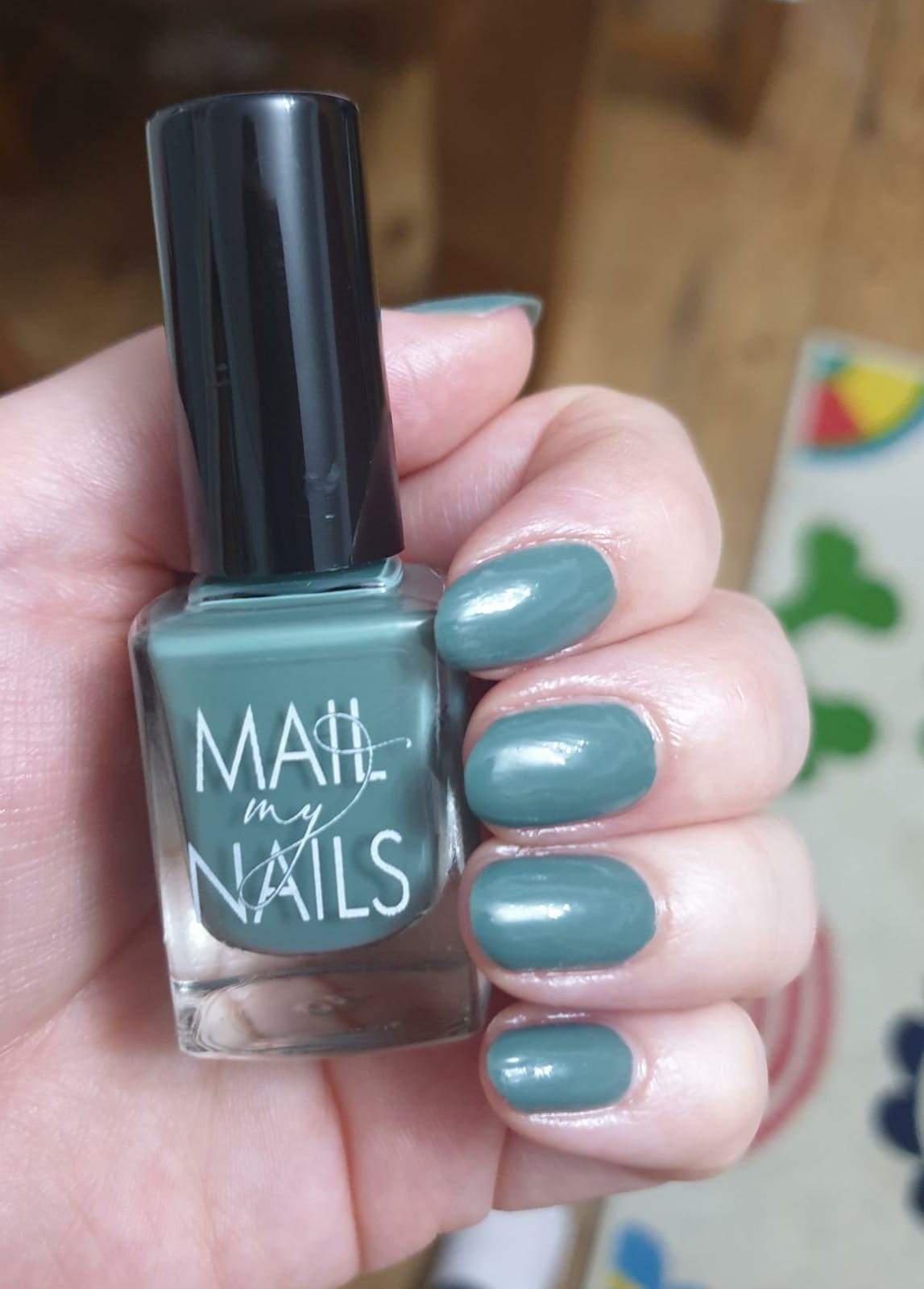 Customer swatch of olive green nail polish on nails, at home.