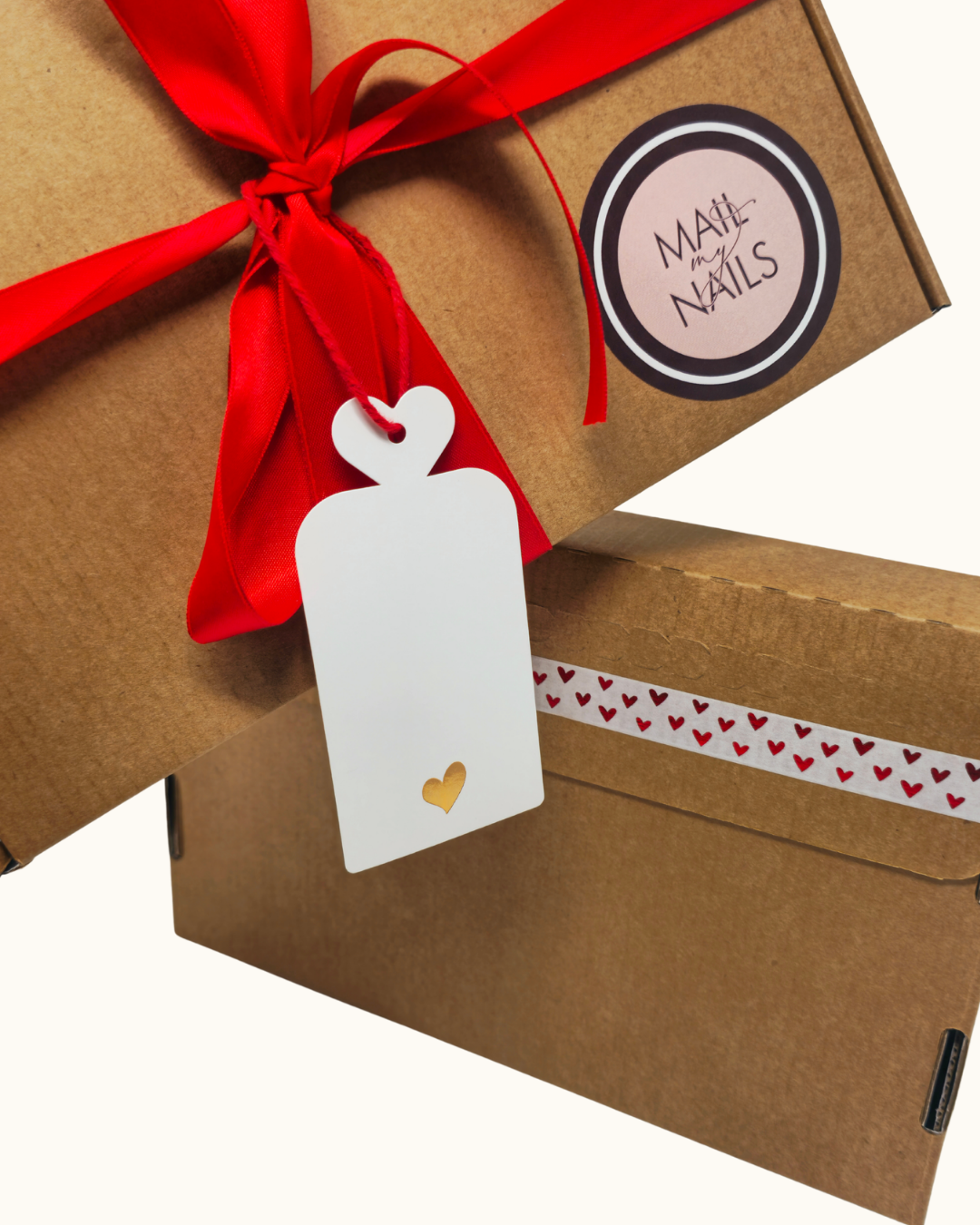 Gift box with red ribbon and white tag, featuring 'Mail My Nails' label.